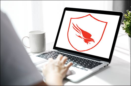 remote worker’s laptop with CrowdStrike logo on screen